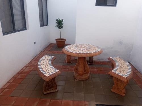 a patio with three tables and a potted plant at DOLPHIN Maeva Residencial in Puerto Peñasco