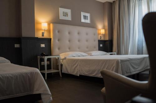 Un ou plusieurs lits dans un hébergement de l'établissement Hotel Mediterraneo