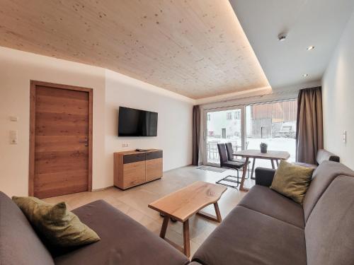 a living room with a couch and a table at Gästehaus Sonne in Bichlbach