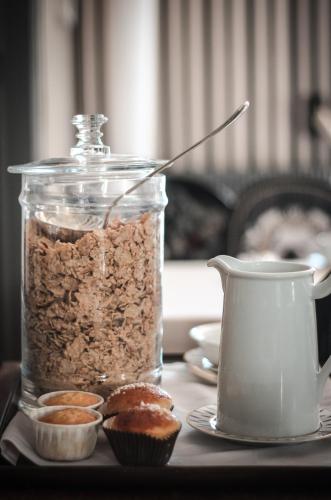 a jar of granola and muffins on a table at La Chapelle Saint Martin in Nieul