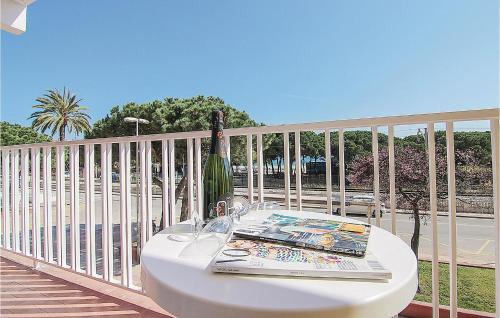 a white table on a balcony with a book on it at Awesome Apartment In Malgrat De Mar in Malgrat de Mar
