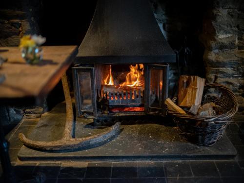 
a fire place in a brick building with a fire hyrdant at Burgh Island Hotel in Bigbury on Sea
