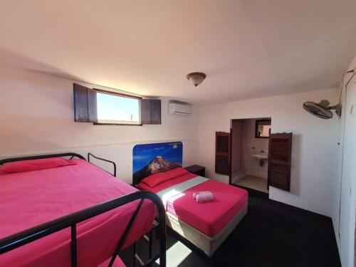 Volcano Hostel tesisinde bir odada yatak veya yataklar