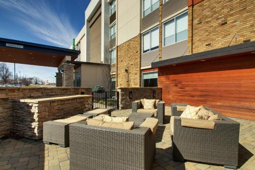 a patio with chairs and couches in front of a building at Holiday Inn Express & Suites Wapakoneta by IHG in Wapakoneta