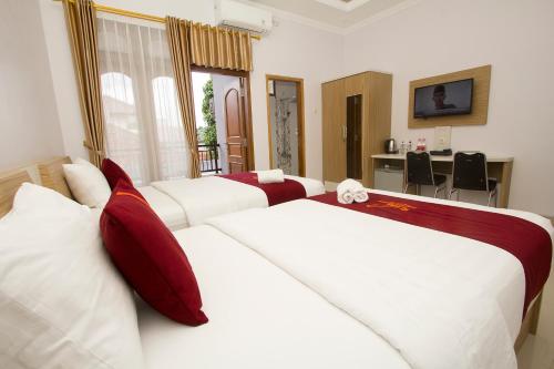 Ένα ή περισσότερα κρεβάτια σε δωμάτιο στο Banua Raya Homestay