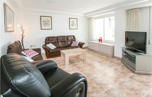 a living room with leather furniture and a flat screen tv at Nice Apartment In Santa Pola in Santa Pola