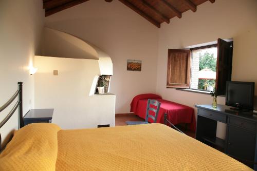 a bedroom with a yellow bed and a red chair at Galea Farm House in Riposto