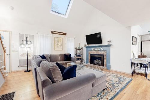 a living room with a couch and a fireplace at Olde Homestead Hideaway in Harwich