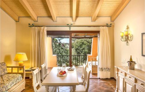 a kitchen and dining room with a table and a couch at Bilo 4 in Porto Cervo