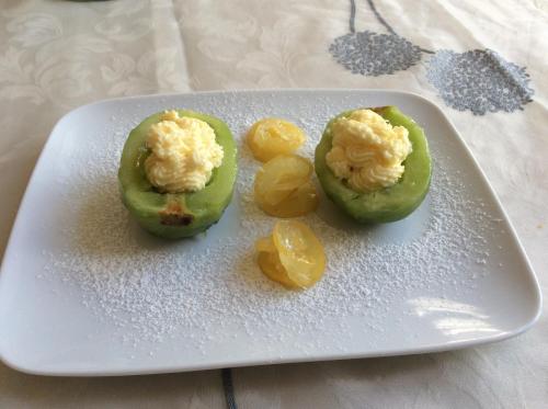 two green peppers with eggs on a white plate at Palazzo Muro Leccese Relais de Charme & Wellness in Muro Leccese
