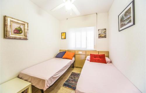 a room with two beds and a window at 2 Bedroom Lovely Apartment In Cabanes in Cabanes