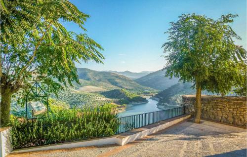 a view of a river from a hill with trees at Awesome Home In Iznájar in Iznájar