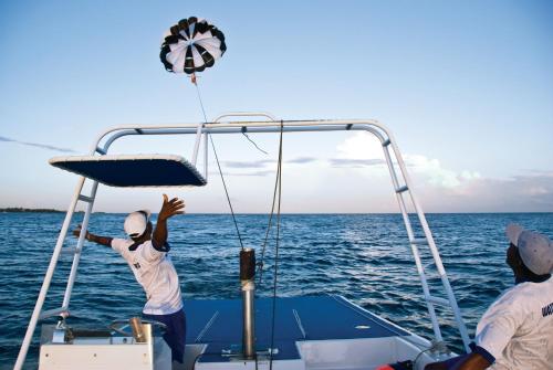 two men on a boat in the water at Half Moon in Montego Bay