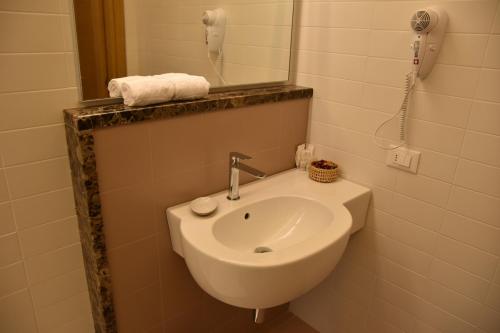 a bathroom with a white sink and a mirror at Casa Nostra in Selva del Montello