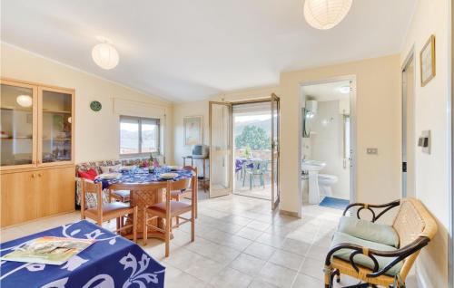 a kitchen and dining room with a table and chairs at Casa Camilla 2 in Cala Gonone