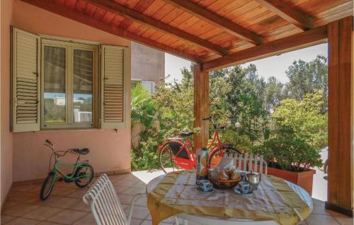 a patio with a table and two bikes on a porch at La Pineta in Lido Signorino