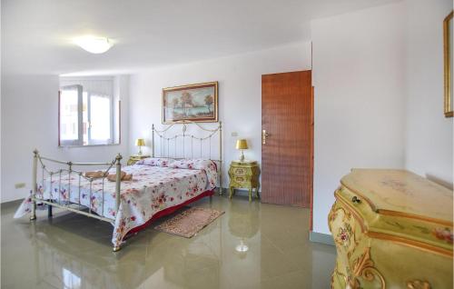 a bedroom with a bed and a wooden door at Gorgeous Home In Maria Di Castellabate in Santa Maria di Castellabate