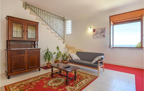 a living room with a couch and a table at Gorgeous Home In Maria Di Castellabate in Santa Maria di Castellabate