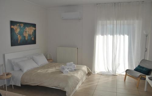 a white bedroom with a bed and a window at Harmony Studio in Athens