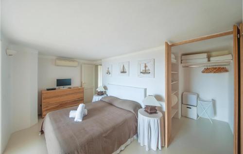 a bedroom with a bed and a desk and a tv at Bellavista in Porto Rotondo
