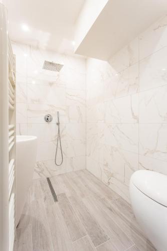 une salle de bain blanche avec des toilettes et un lavabo dans l'établissement MBM - Paradis, à Paris