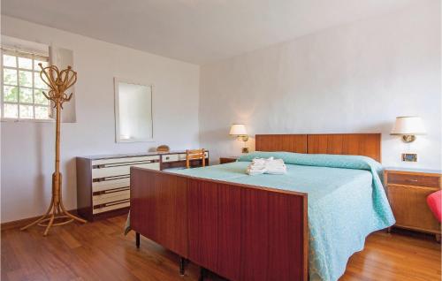 a bedroom with a bed and a dresser and a window at Casa Fulvia in Camaiore