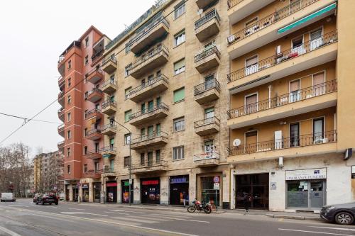 a large building on a city street with a street at Corsica Huge Terrace Flats in Milan
