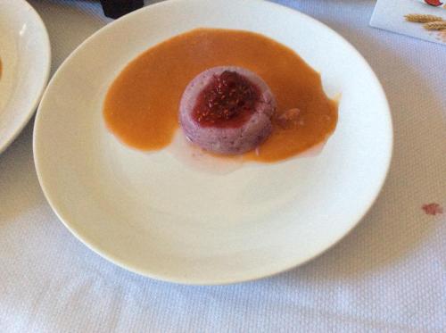 a white plate with a dessert on a table at Palazzo Muro Leccese Relais de Charme & Wellness in Muro Leccese