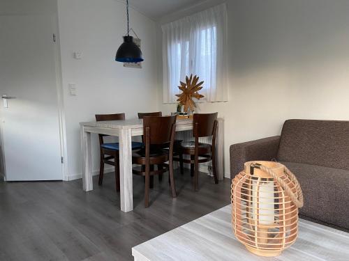 a living room with a table and chairs and a couch at Chalet 505 op Recreatiepark De Wielen in Sint Maarten