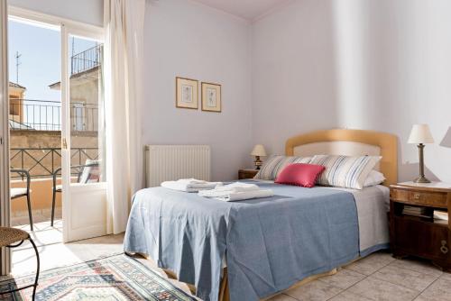 a bedroom with a bed with a blue blanket at Corfu Garitsa Spacious Apartment in Corfu