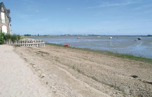 a beach with a fence next to a body of water at Awesome Home In Morsalines With Wifi in Morsalines