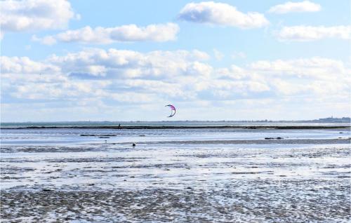 a person is flying a kite on the beach at Awesome Home In Morsalines With Wifi in Morsalines