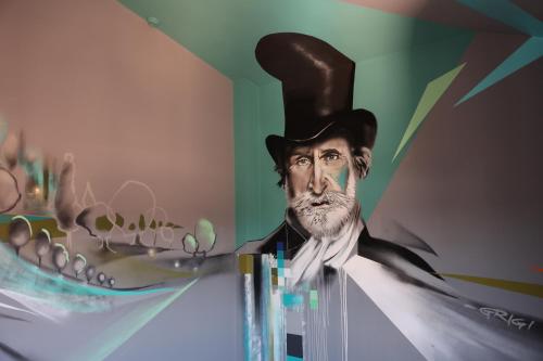 a painting of a man wearing a top hat at Muraless Art Hotel - WorldHotels Crafted in Castel d'Azzano