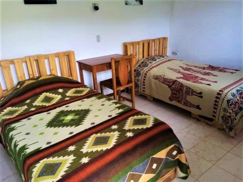 2 Betten nebeneinander in einem Zimmer in der Unterkunft La Estancia de Runtún Km 7 in Baños