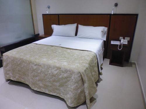 a bedroom with a large bed with white sheets at Hotel Athos in Buenos Aires