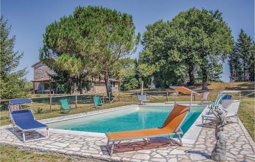 a swimming pool with two chairs and a swimming pool at Maurizia in Bagnoregio