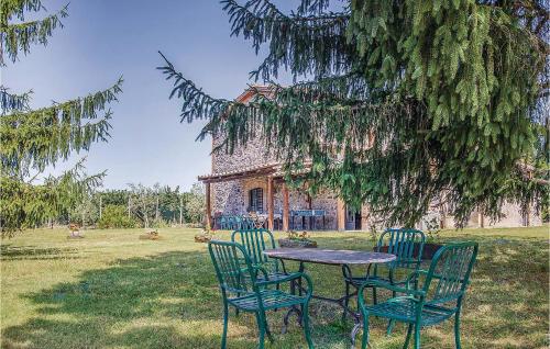 a table and chairs in front of a building at Maurizia in Bagnoregio