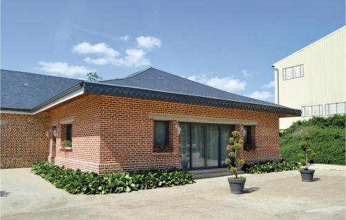 a brick house with plants in front of it at 4 Bedroom Lovely Home In Roisel in Roisel