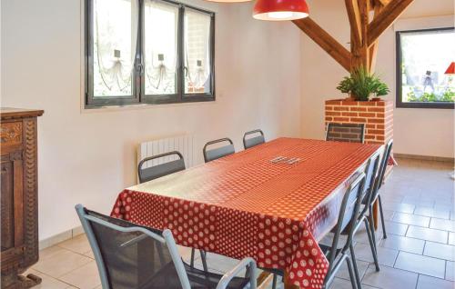 a dining room with a red table and chairs at 4 Bedroom Lovely Home In Roisel in Roisel