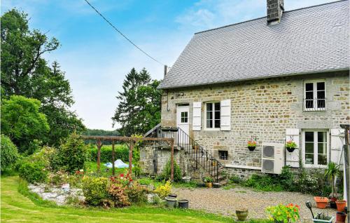 a brick house with a garden in front of it at Stunning Home In Saint-Sever-Calvados in Saint-Sever-Calvados