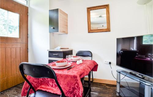 a dining room with a table with a red table cloth at Stunning Home In Saint-Sever-Calvados in Saint-Sever-Calvados