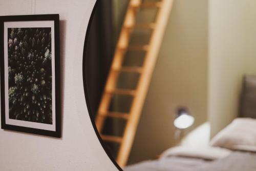 a picture hanging on a wall next to a ladder at Stilvolles City-Loft mit privatem Whirlpool in Trier