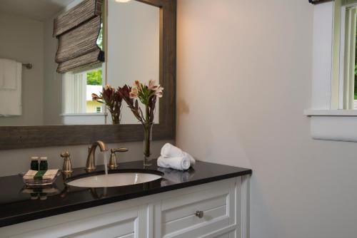 a bathroom with a sink and a mirror at Lake Bomoseen Lodge in Bomoseen