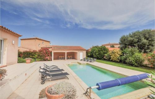 a swimming pool with lounge chairs and a large at Cozy Home In Villelongue in Villelongue-de-la-Salanque