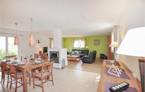 a dining room and living room with a table and chairs at Cozy Home In Villelongue in Villelongue-de-la-Salanque