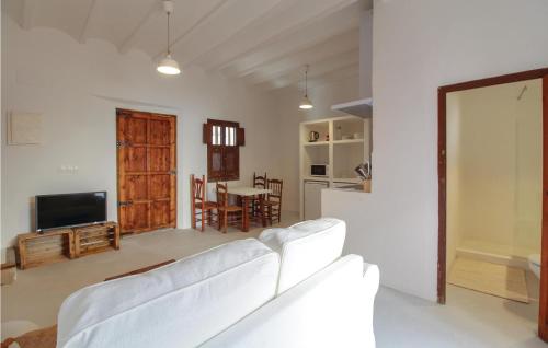 a living room with white furniture and a kitchen at Amazing Apartment In Altea With Kitchen in Altea