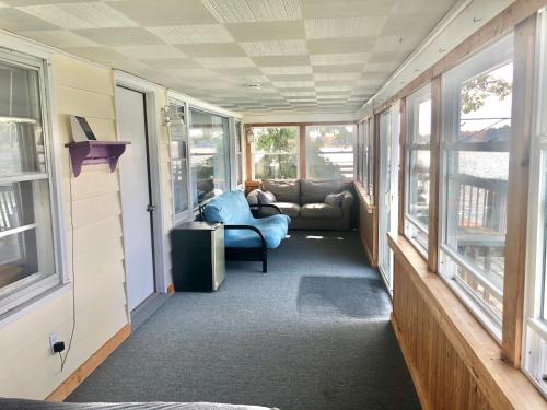 a room with a couch and a chair in a house at Lake Front Home Near Peek'n Peak in Findley Lake