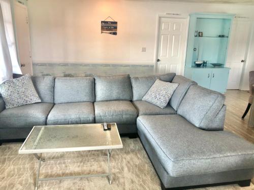 a living room with a couch and a coffee table at Lake Front Home Near Peek'n Peak in Findley Lake