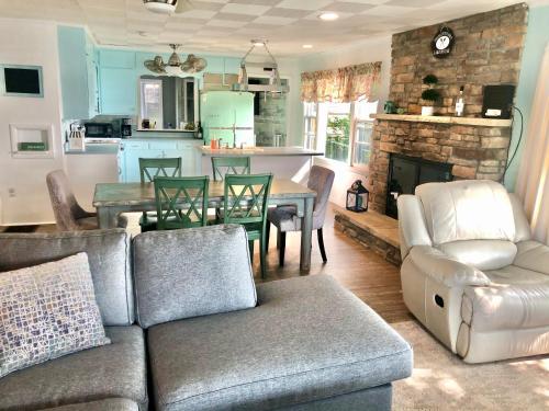 a living room with a couch and a table at Lake Front Home Near Peek'n Peak in Findley Lake