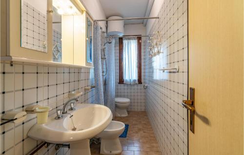 a bathroom with two toilets and a sink at Pigne in Rosolina Mare